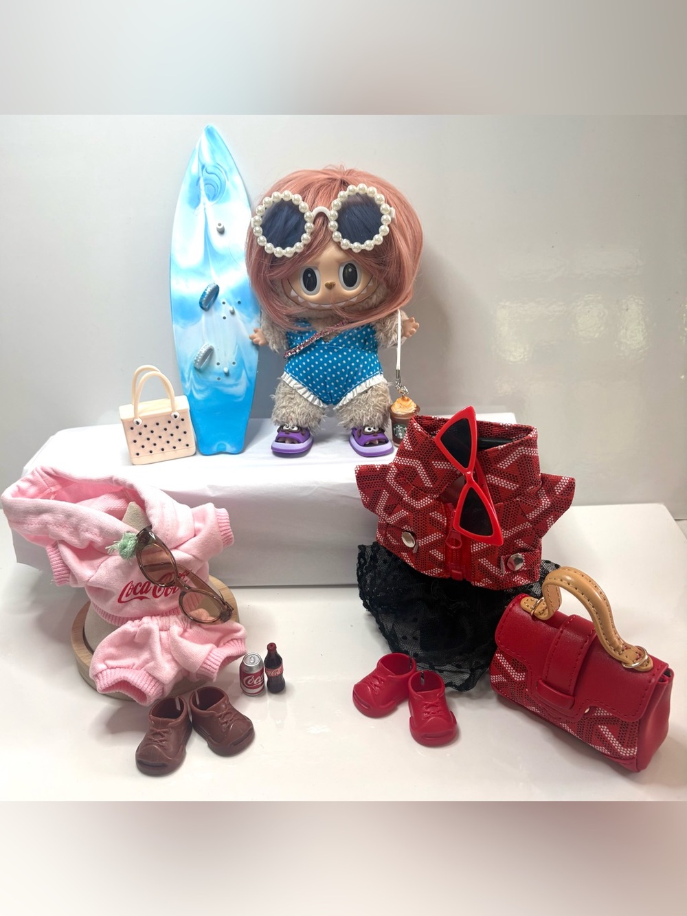 3 Complete Fits, including surfer outfit and jogger set. Doll NOT included.
